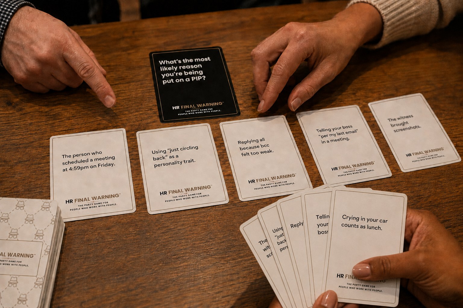 Players reacting to a black prompt card during HR Final Warning